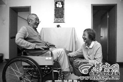姚世瑗给轮椅上的老伴儿李祥生按摩双腿 实习记者马捷文摄